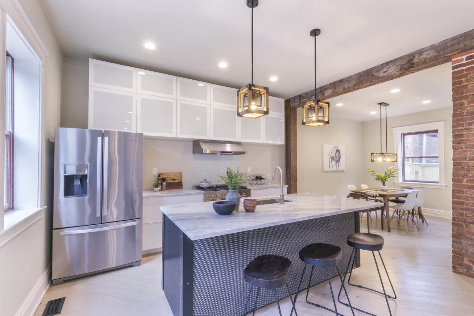 A modern kitchen features stainless steel appliances and a large kitchen island.